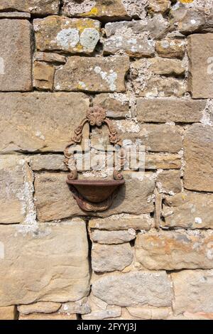 decorative metal bird bath or planter on stone wall at farm in Hadrian's Wall Northumberland Stock Photo