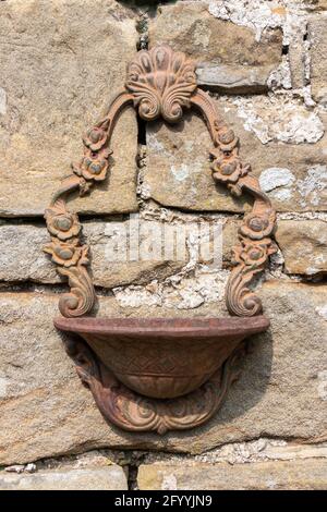 decorative metal bird bath or planter on stone wall at farm in Hadrian's Wall Northumberland Stock Photo