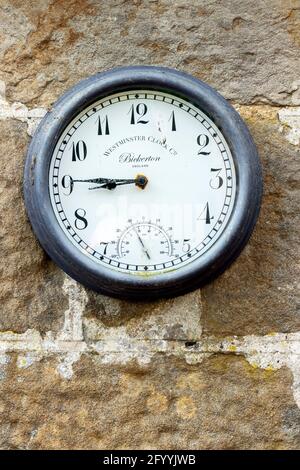 old clock on stone wall outside cottage at St Oswalds farm Hadrian's Wall Northumberland Stock Photo