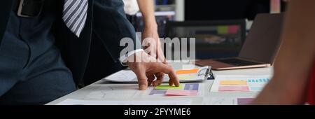 Business people studying charts and documents at table in office Stock Photo