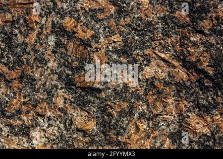Texture of natural granite with veins of yellow. The mineral cut. Can be used as a background. Stock Photo