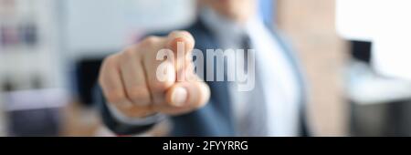 Man in business suit pointing his finger in front of him closeup Stock Photo