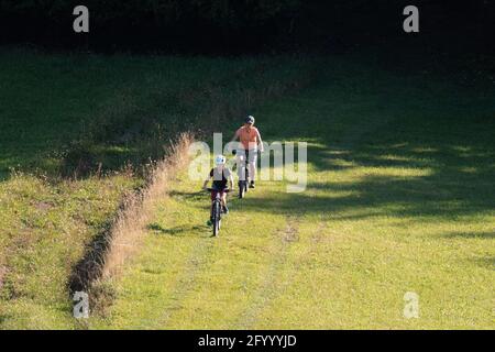 Two girls on mtb bikes. Mother and daughter riding on a trail. Stock Photo