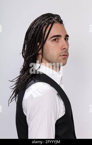 Stylish male model with afro braids posing in studio on isolated background. Style, trends, fashion concept. Stock Photo