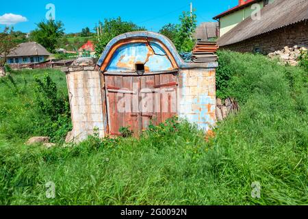 Ancient Cellar for storing wine , exterior view . Old rural cellar with wooden door Stock Photo