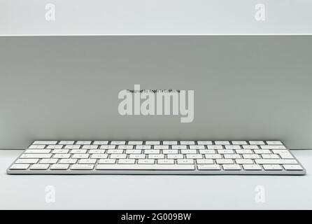 Bologna - Italy - April 12, 2021: New iMac 21,5 inch keyboard personal computer made by Apple Computers, isolated on white background. Side view Stock Photo