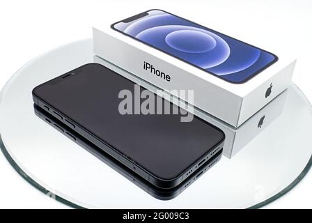 Bologna - Italy - April 27, 2021: iPhone 12 smartphone with box developed by Apple Inc. isolated on white background. Stock Photo