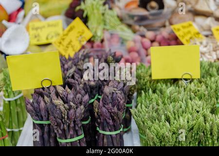 Bunch of various Asparagus sold in front of farmer market stall in Germany. Stock Photo