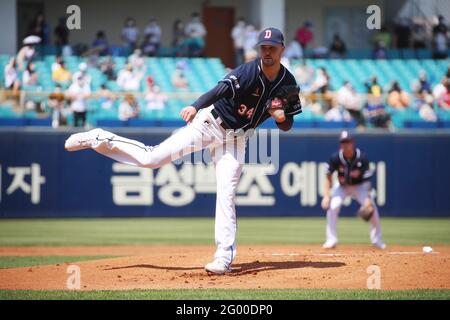 Outfielder Kim In-Tae of Doosan Bears scores a run into the home