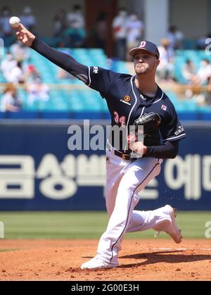 Outfielder Kim In-Tae of Doosan Bears scores a run into the home