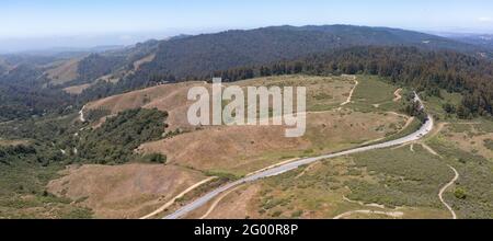 Trails meander through the vegetation-covered hills of the East Bay, just a few miles from San Francisco Bay in Northern California. Stock Photo