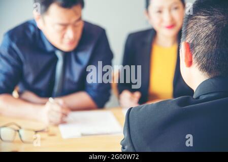 Job applicants having an interview with Human resource manager jobs interview with confident candidate in an office. Stock Photo