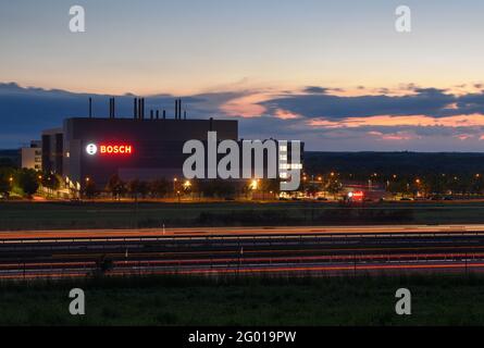 Dresden, Germany. 28th May, 2021. Cars pass in the evening on highway 4 in front of the new semiconductor factory of Bosch (shot with long time exposure). The plant will go into operation on 07.06.2021. Credit: Robert Michael/dpa-Zentralbild/dpa/Alamy Live News Stock Photo