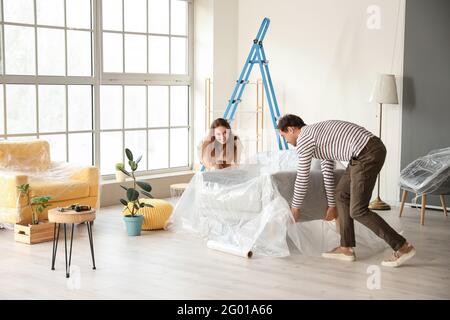 Happy couple doing repair in their new house Stock Photo