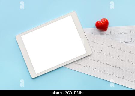Tablet computer with red heart and cardiogram on color background Stock Photo