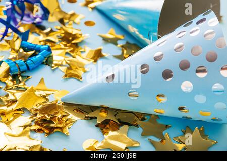 Party cones and confetti on color background Stock Photo