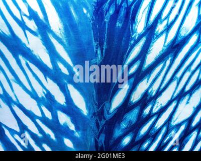 Indigo blue fabric tie dye pattern background. Indigo-Dyed fabric texture with abstract ethnic graphic motif pattern. Stock Photo