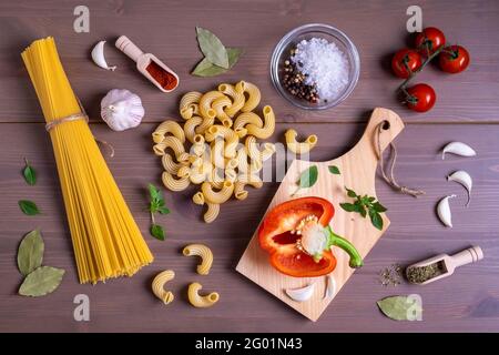 Close-up top view of ingredients for making Italian pasta. Healthy and wholesome food concept. Selective focus. Stock Photo