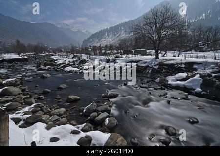 Full Moon light view of Pahalgam valley with Lidder river, Kashmir. Shot in January  2021, during the harshest winter period of Chilla Kalan Stock Photo