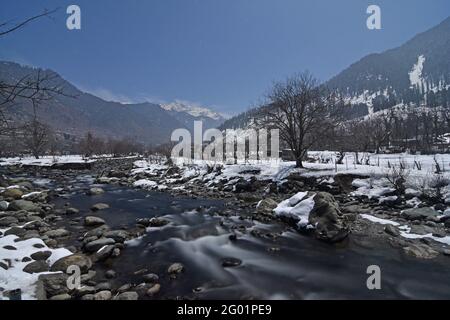 Full Moon light view of Pahalgam valley with Lidder river, Kashmir. Shot in January  2021, during the harshest winter period of Chilla Kalan Stock Photo