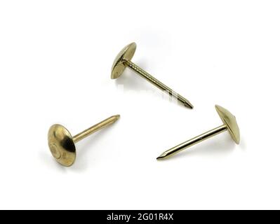 three golden pushpins isolated on white background Stock Photo