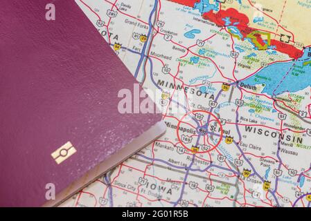 passport over map. Focus on the Minnesota North American continent. Emigration, travel, destination concept.Top view,close-up. Stock Photo