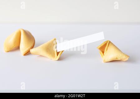 Asian Chinese fortune cookies with blank paper for the text on white table Stock Photo