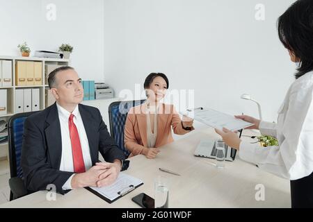 HR manager asking applicant to fill form before interview Stock Photo ...