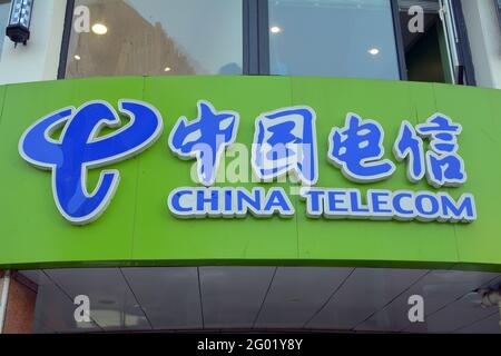 China telecom logo above a mobile phone shop in China. Writing in both Chinese and English Stock Photo