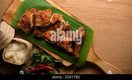 Top view of Thai-Style Grilled Chicken with sticky rice on wooden tray, Thai food Stock Photo