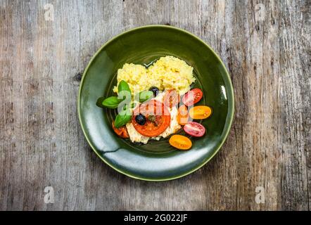 Eating healthy. Food plate, overhead. Vegetables with couscous, mediterranean vegetarian dish, cooking concept Stock Photo