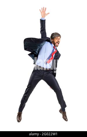Triumphant excited businessman in stylish suit leaping in the air yelling in celebration of a personal success in a full length portrait isolated over Stock Photo