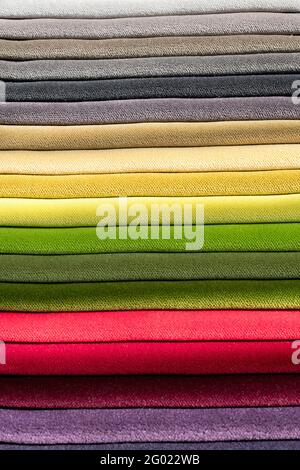 Samples pf velvet fabric in the colors of the rainbow or spectrum neatly stacked in a full frame close up view of the weave of the textile Stock Photo