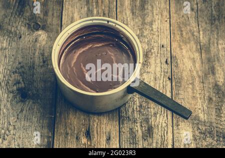 Hot chocolate drink melted in a pot, cooking of dessert homemade Stock Photo