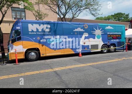 A mobile vaccination bus parked on 31st Avenue in Astoria, Queens, New York. Stock Photo