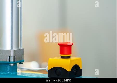 The red emergency button or stop button for Hand press. STOP Button for industrial machine, Emergency Stop for Safety. Stock Photo