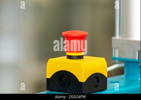 The red emergency button or stop button for Hand press. STOP Button for industrial machine, Emergency Stop for Safety. Stock Photo