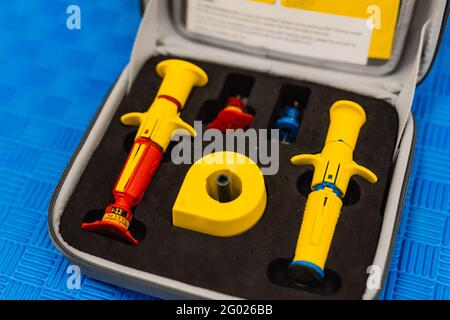 First aid kit content, isolated against blue background. first aid medical equipment Stock Photo