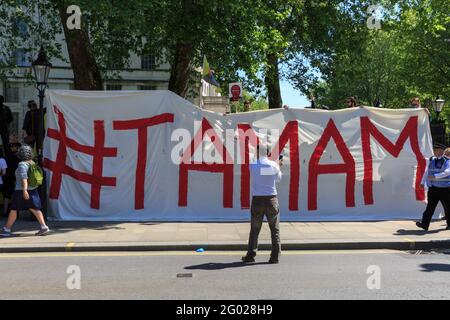 Kurdish Protesters hold a banner saying 'Tamam' commenting on the arrival of Turkish president Erdogan in Westminster, London, UK Stock Photo