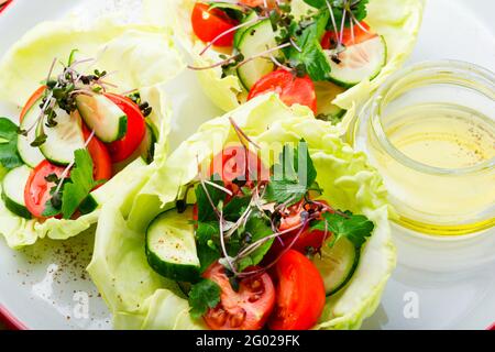 Vitamin summer salad with cabbage,cucumber,tomato and micro greens Stock Photo