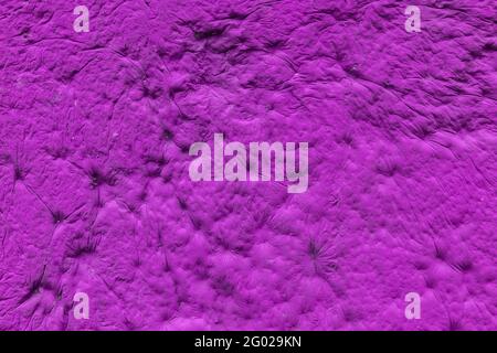 pink sculpturesque plaster with decorative indentation finish wall texture and background Stock Photo
