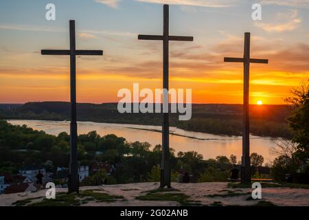 Three wooden crosses on the hill above the city Stock Photo