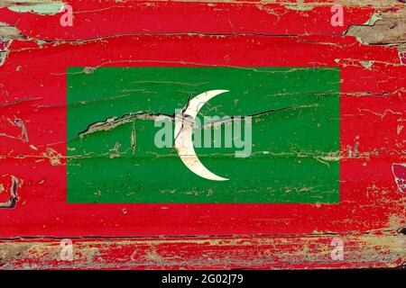 3D Flag of Maldives on a old wood wall background. Stock Photo