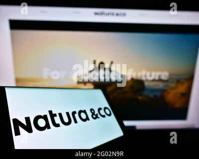 Smartphone with logo of Brazilian personal care company Natura Co Holding  SA on screen in front of business website. Focus on left of phone display  Stock Photo - Alamy