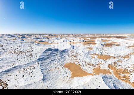 Shiny White Desert landscape with a clear blue sky Stock Photo