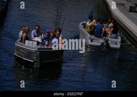 People enjoy the hot weather in a goboat at Paddington Basin, north London, as Bank Holiday Monday could be the hottest day of the year so far - with temperatures predicted to hit 25C in parts of the UK. Picture date: Monday May 31, 2021. Stock Photo