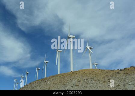Panoramic view of a row of modern wind mills on a hill in Tehachapi, California, USA.  Note the large frame format. Stock Photo
