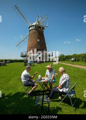 Thaxted Essex, UK. 31st May, 2021. Bank Holiday Summer tea and cake in the grounds of John Webbs Windmill (Thaxted Windmill). quintessential British summer scene. Enjoying the summer sun and tea and cake from the Giddy Up Bar and Teacup in the grounds of John Webbs Windmill in Thaxted northwest Essex. Photograph Credit: BRIAN HARRIS/Alamy Live News Stock Photo