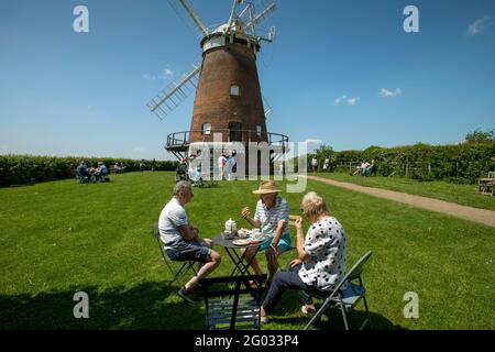 Thaxted Essex, UK. 31st May, 2021. Bank Holiday Summer tea and cake in the grounds of John Webbs Windmill (Thaxted Windmill). quintessential British summer scene. Enjoying the summer sun and tea and cake from the Giddy Up Bar and Teacup in the grounds of John Webbs Windmill in Thaxted northwest Essex. Photograph Credit: BRIAN HARRIS/Alamy Live News Stock Photo