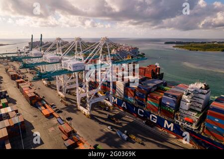 Miami, FL, USA - May 29, 2021: Port of Miami cranes loading a cargo ship with containers Stock Photo